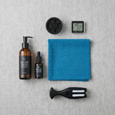 Various essential acoustic guitar maintenance accessories laid out, including a microfiber cloth, polish, humidifier, and string winder, emphasizing comprehensive care.